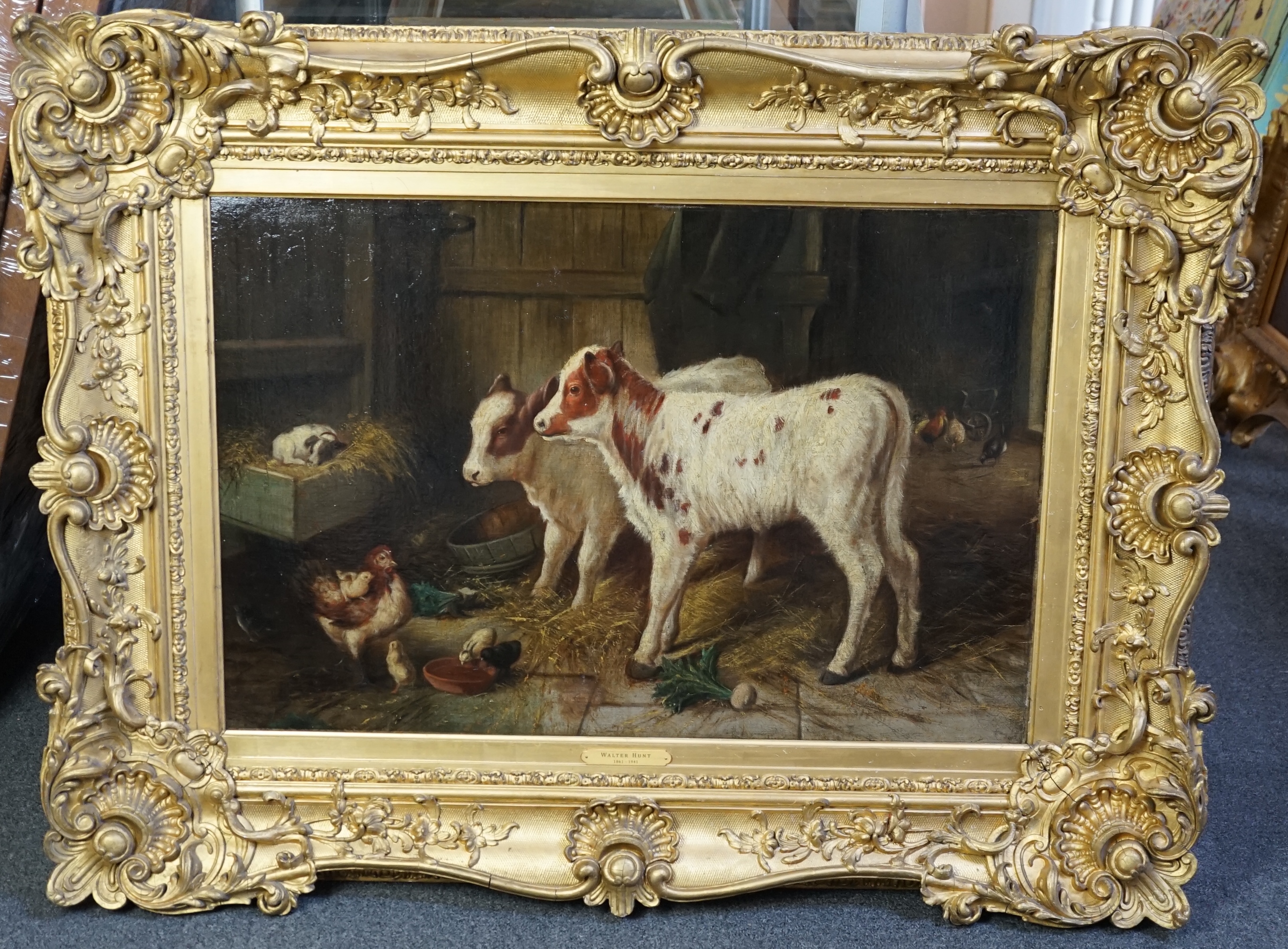 Walter Hunt (1861-1941), Calves, a puppy and poultry in a barn, oil on canvas, 50 x 75cm